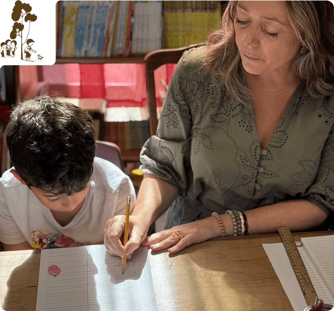 A Scripps Montessori teacher guiding an Elementary student through handwriting